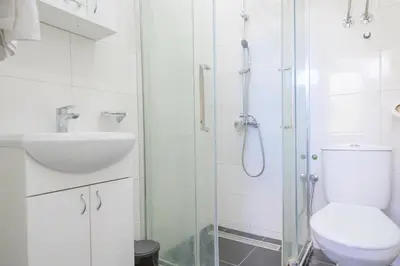 a bathroom with a shower and a toilet and a sink at Studio Simonovic in Vrnjačka Banja