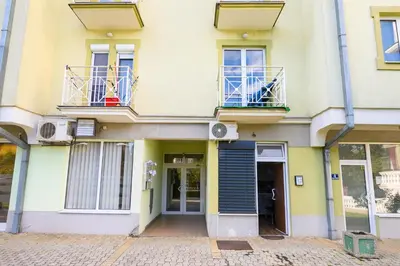 a building with two balconies and a door at Studio Simonovic in Vrnjačka Banja