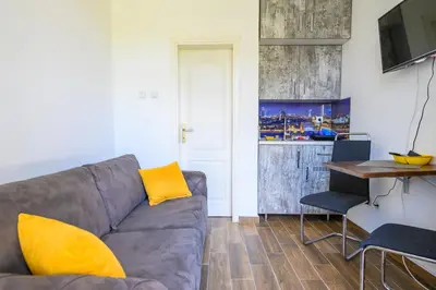 a living room with a couch and a table at Studio Simonovic in Vrnjačka Banja