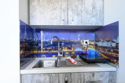 a kitchen with a sink and a view of a city at Studio Simonovic in Vrnjačka Banja