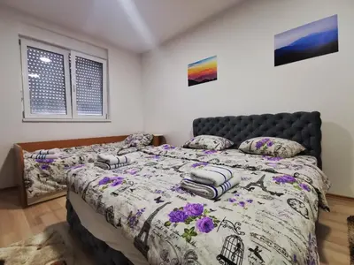 a bedroom with a bed with a comforter and pillows at Cozy Corner Apartments - Free parking & Wi-fi in Ćuprija