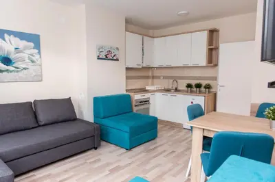 a living room with a couch and a table and chairs at Studio Borići in Soko Banja