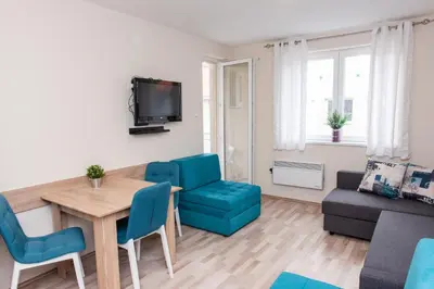 a living room with a table and chairs and a couch at Studio Borići in Soko Banja