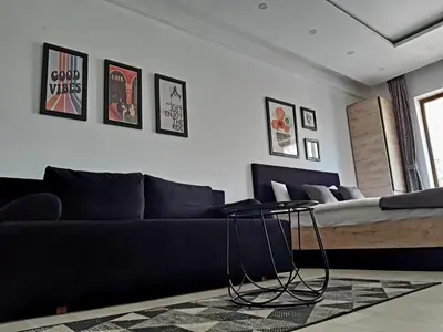 a living room with a couch and a table at Kopaonik Milmari L42 in Kopaonik