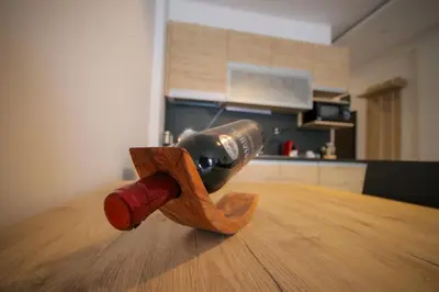 a wine bottle on top of a wooden table at Kopaonik Milmari L42 in Kopaonik