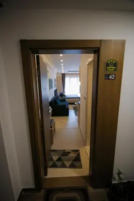 a hallway with a door open to a living room at Kopaonik Milmari L42 in Kopaonik
