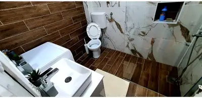 a bathroom with a white toilet and a sink at Apartman Tadeus in Soko Banja