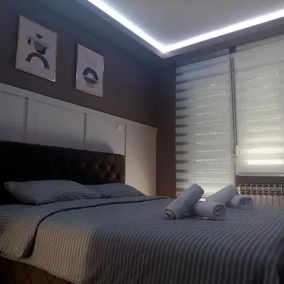 a bedroom with a bed with two towels on it at Apartman Tadeus in Soko Banja