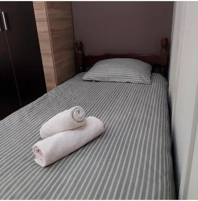 a bed with two towels sitting on top of it at Apartman Tadeus in Soko Banja