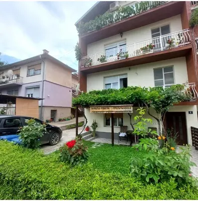 a building with a car parked in front of it at Apartman Tadeus in Soko Banja