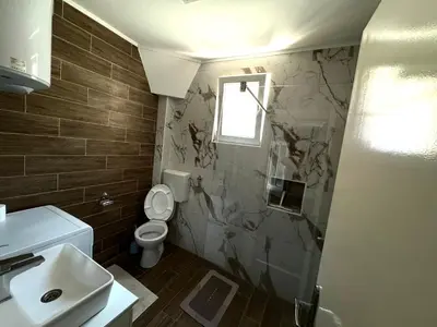 a bathroom with a toilet and a sink at Apartman Tadeus in Soko Banja