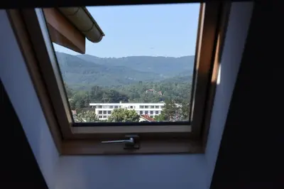 a window with a view of a mountain at Apartman TRIM in Vrnjačka Banja