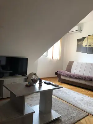 a living room with a couch and a table at Apartman TRIM in Vrnjačka Banja