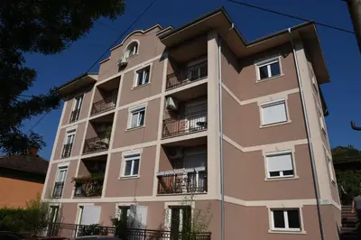 a tall building with balconies on it at Apartman TRIM in Vrnjačka Banja