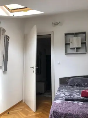 a bedroom with a bed and a ceiling at Apartman TRIM in Vrnjačka Banja
