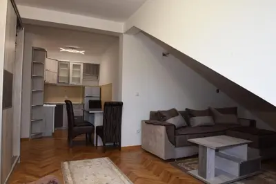 a living room with a couch and a table at Apartman TRIM in Vrnjačka Banja