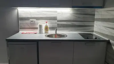 a kitchen counter with a sink and a bottle of soap at Apartman Sweet dreams 2 in Niš