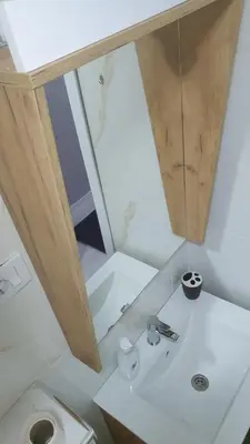 a bathroom with a sink and a toilet at Apartman Sweet dreams 2 in Niš