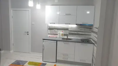a kitchen with white cabinets and a sink at Apartman Sweet dreams 2 in Niš