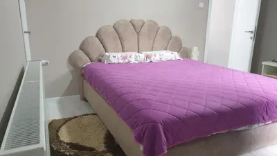 a purple bed with a purple comforter in a room at Apartman Sweet Dreams 3 in Niš