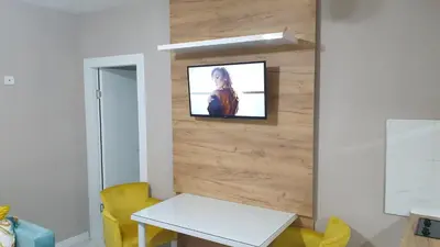 a living room with a tv on a wall at Apartman Sweet Dreams 3 in Niš