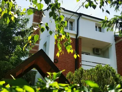 an external view of a white building with trees at Vila Breza in Soko Banja