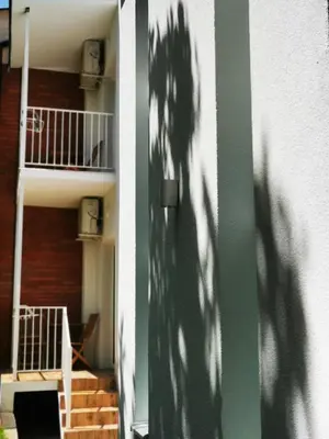 a shadow of a tree on the side of a building at Vila Breza in Soko Banja