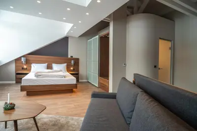 a bedroom with a bed and a couch at Vila Emilia in Vrnjačka Banja