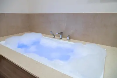 a bath tub filled with a white cloud at Vila Emilia in Vrnjačka Banja