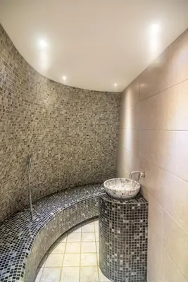 a bathroom with a sink in a tiled wall at Vila Emilia in Vrnjačka Banja