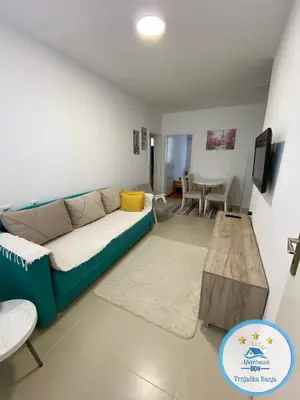 a living room with a couch and a table at Don in Vrnjačka Banja