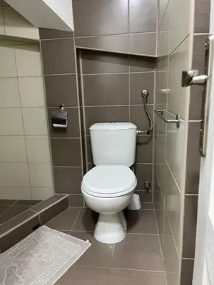 a bathroom with a white toilet in a stall at Apartman Jovana in Soko Banja