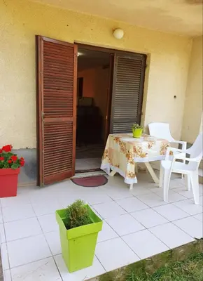 a table and chairs on a patio with a table and a table and chairs at Apartman Sergej 2 in Soko Banja