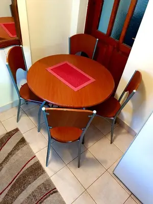 a wooden table and chairs with a red napkin on it at Apartman Sergej 2 in Soko Banja