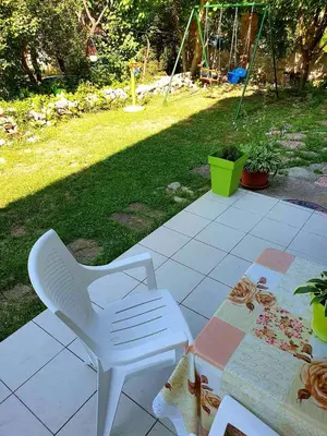 a white chair and a table on a patio at Apartman Sergej 2 in Soko Banja
