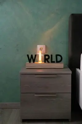 a wooden dresser with a candle on top of it at Apartments Due Mondi in Vrnjačka Banja