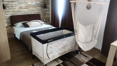a bedroom with a bed and a swing at Apartments Due Mondi in Vrnjačka Banja