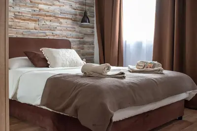 a bedroom with a bed with two towels on it at Apartments Due Mondi in Vrnjačka Banja
