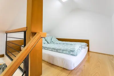 a room with a bed with a blue blanket on it at Kompleks apartmana SuperStar23A in Soko Banja