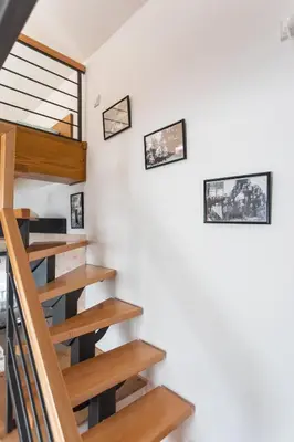 a staircase in a house with wooden railings at Kompleks apartmana SuperStar23A in Soko Banja