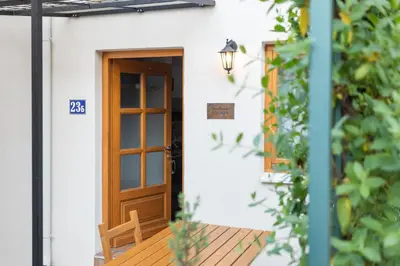 a door to a house with a wooden deck at Kompleks apartmana SuperStar23A in Soko Banja