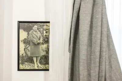 a picture of a woman standing next to a curtain at Kompleks apartmana SuperStar23A in Soko Banja