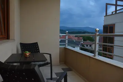 a balcony with a table and chairs and a view at Apartman Favorito 327 in Vrnjačka Banja