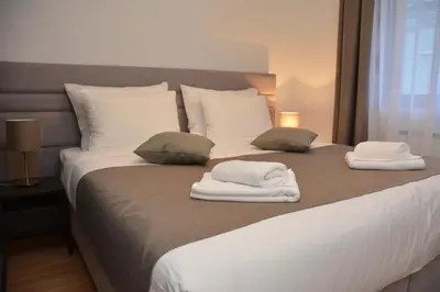 a bedroom with a bed with towels on it at Apartman Favorito 327 in Vrnjačka Banja