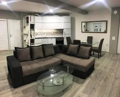 a living room with a couch and a table at Niš Apartman Lux in Niš