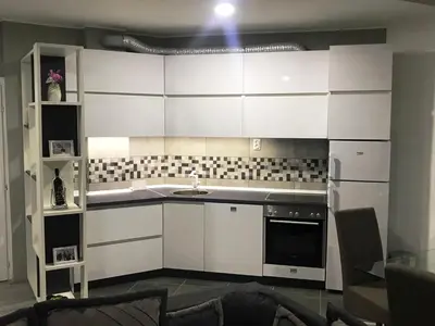 a kitchen with white cabinets and a sink at Niš Apartman Lux in Niš