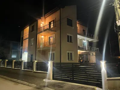 a building at night with lights in front of it at Niš Apartman Lux in Niš