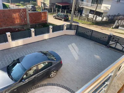 a car parked on top of a parking lot at Niš Apartman Lux in Niš