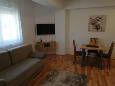 a living room with a couch and a table at Apartmani & SPA Matin Breg in Jošanička Banja