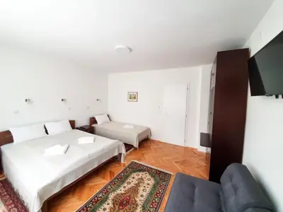 a living room with two beds and a couch at Smestaj Katarina in Soko Banja